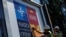 Workers paste the posters announcing the NATO Summit outside the Madrid Fair before a NATO summit in Madrid, June 27, 2022.
