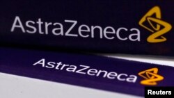 FILE - The logo of AstraZeneca is seen on medication packages in a pharmacy in London. Apr. 28, 2014.