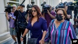 Lizzette Martinez, author of "Jane Doe #9: How I Survived R. Kelly," left, arrives at federal court, June 29, 2022, in the Brooklyn borough of New York to witness the sentencing of R&B star R. Kelly in a sex trafficking case. Kelly was given 30 years in prison.