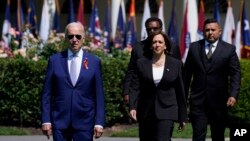 President Joe Biden and Vice President Kamala Harris, arrive for an event to celebrate the passage of the "Bipartisan Safer Communities Act," a law meant to reduce gun violence, on the South Lawn of the White House, July 11, 2022. 
