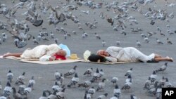 Pigeons surround pilgrims outside the the Grand Mosque in the Saudi Arabia's holy city of Mecca.