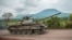 FILE - A Congolese army tank heads towards the front line near Kibumba in the area surrounding the North Kivu city of Goma during clashes between the Congolese army and M23 rebels, May 25, 2022.