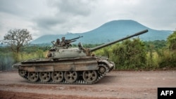 FILE - A Congolese army tank heads towards the front line near Kibumba in the area surrounding the North Kivu city of Goma during clashes between the Congolese army and M23 rebels, May 25, 2022.