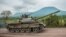 FILE - A Congolese army tank heads towards the front line near Kibumba in the area surrounding the North Kivu city of Goma during clashes between the Congolese army and M23 rebels, May 25, 2022.