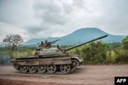 FILE - A Congolese army tank heads towards the front line near Kibumba in the area surrounding the North Kivu city of Goma during clashes between the Congolese army and M23 rebels, May 25, 2022.