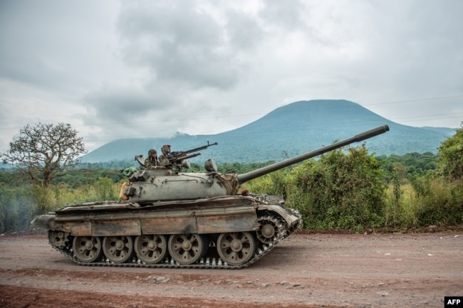 FILE - A Congolese army tank heads towards the front line near Kibumba in the area surrounding the North Kivu city of Goma during clashes between the Congolese army and M23 rebels, May 25, 2022.