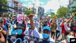 FILE - In this May 12, 2021, photo, anti-coup protesters march during a demonstration in Yangon, Myanmar. 