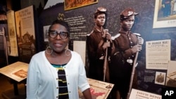 Pamela Junior, director of The Two Mississippi Museums, speaks about the historical roots of Juneteenth, as she stands before one of the exhibits in the Mississippi Civil Rights Museum, June 16, 2022, in Jackson.