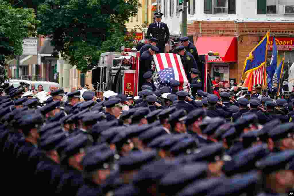 The remains of Lt. Sean Williamson, a 27-year veteran of the Philadelphia Fire Department, are brought to Epiphany of Our Lord Catholic Church for funeral mass in Philadelphia, Pennsylvania.&nbsp;Williamson was killed in an early morning building collapse on June 18.