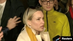 Marina Ovsyannikova speaks to the media as the leaves the court building in Moscow, Russia, March 15, 2022 in this still image taken from a video. (Reuters TV via Reuters)