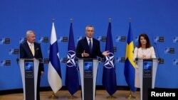 Sweden's Foreign Minister Ann Linde and Finland's Foreign Minister Pekka Haavisto attend a news conference with NATO Secretary General Jens Stoltenberg, after signing their countries' accession protocols at the alliance's headquarters in Brussels, Belgium 7.5.22