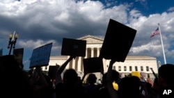 FILE - Activists demonstrate after the decision to overturn Roe v. Wade, outside the Supreme Court in Washington, June 25, 2022.