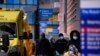 FILE - Ambulances line up outside the Royal London Hospital in the Whitechapel area of east London, Thursday, Jan. 6, 2022. 