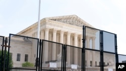 Police barriers are visible in front of the Supreme Court in Washington, July 1, 2022.