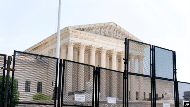 Police barriers are visible in front of the Supreme Court in Washington, July 1, 2022.