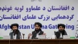 FILE - Taliban spokesman Zabihullah Mujahid, center, speaks during a press conference in Kabul on June 30, 2022.