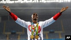 FILE - In this Aug. 20, 2016, file photo, Britain's Mo Farah celebrates winning the gold medal in the men's 5,000 meters at the 2016 Summer Olympics in Rio de Janeiro, Brazil