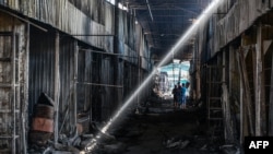 A man looks at the damage caused to the central market in Sloviansk by a suspected missile attack, on July 6, 2022.