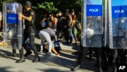 A protester is detained during the LGBTQ Pride March in Ankara, Turkey, July 5, 2022. Police in Turkey’s capital broke up an LGBTQ Pride march and detained dozens of people.
