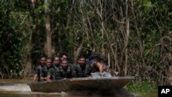 Army soldiers navigate a river during the search for Indigenous expert Bruno Pereira and freelance British journalist Dom Phillips in Atalaia do Norte, Amazonas state, Brazil, Tuesday, June 14, 2022. Police have arrested two suspects.