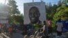A poster features slain Haitian President Jovenel Moise in Port-au-Prince, Haiti, July 7, 2022. A year has passed since Moise was assassinated at his private home.