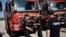 Romanian firefighters, who will reinforce their Greek colleagues during the summer season to tackle wildfires in the country, stand next to their vehicles, in Athens, Greece, July 2, 2022.