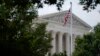 FILE - An American flag waves in front of the U.S. Supreme Court building, June 27, 2022, in Washington.