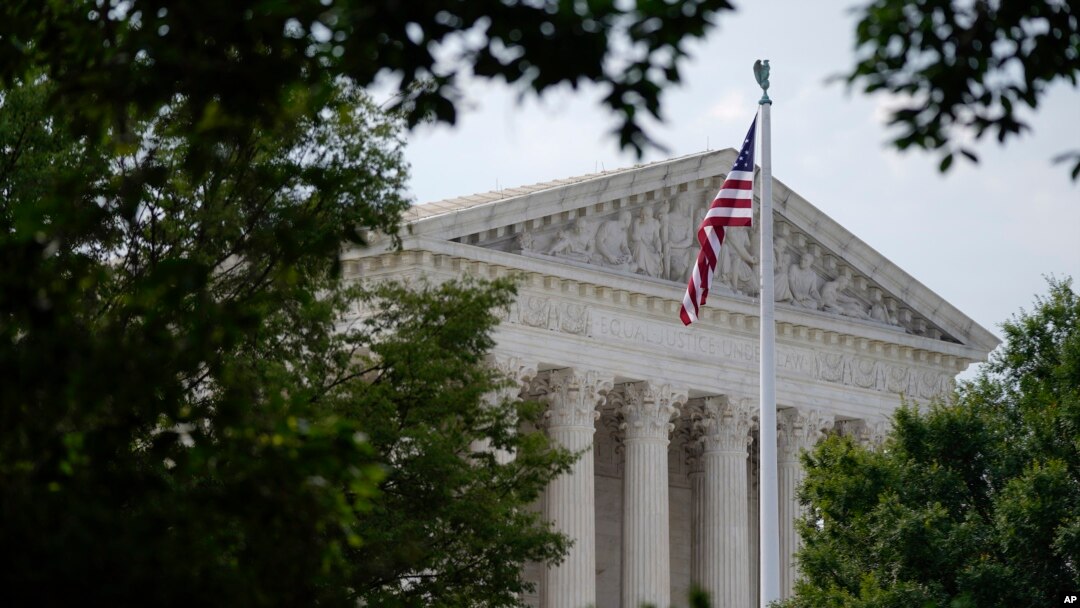 FILE - An American flag waves in front of the U.S. Supreme Court building, June 27, 2022, in Washington.