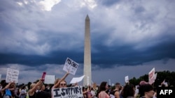 FILE: Abortion rights activists march past the Washington Monument as they protest in Washington, DC, on June 26, 2022, two days after the US Supreme Court scrapped half-century constitutional protections for the procedure.