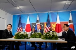 Presiden Joe Biden, tengah, bertemu dengan Presiden Korea Selatan Yoon Suk Yeol, kiri, dan Perdana Menteri Jepang Fumio Kishida, kanan, dalam KTT NATO di Madrid, Rabu, 29 Juni 2022. (Foto: AP)