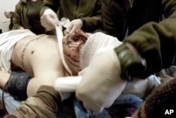 Yuliia Paievska and other paramedics bandage the head of an injured Ukrainian serviceman in Mariupol on February 24, 2022. Using a body camera, she recorded her team's frantic efforts to bring people back from the brink of death. (Yuliia Paievska/via AP)