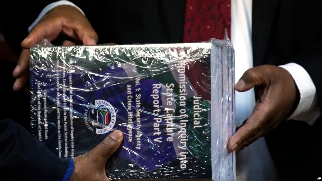 Officials hold copies of the final report of a judicial investigation into corruption in government and state-owned companies during former President Jacob Zuma's tenure from 2009 to 2018, during the official hand-over at Union Building in Pretoria, South Africa, June 22, 2022.