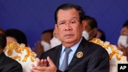 FILE: Cambodian Prime Minister Hun Sen claps during the 71st anniversary celebration of the Cambodian People's Party (CPP) at its headquarters in Phnom Penh, Cambodia, Tuesday, June 28, 2022. (AP Photo/Heng Sinith)