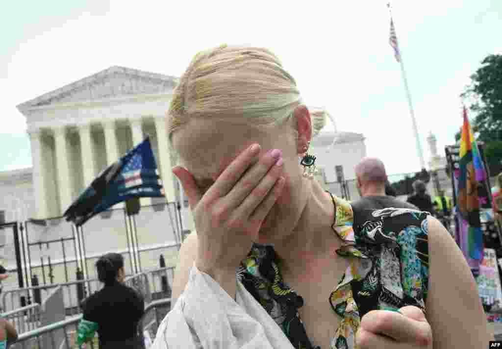 An anti-abortion supporter cries outside the U.S. Supreme Court in Washington.