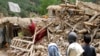 Afghan children stand near a house that was destroyed in an earthquake in the Spera district of the southwestern part of Khost Province, Afghanistan, June 22, 2022.