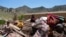 Afghan children sit among their salvaged belongings after an earthquake in Gayan village, in Paktika province, Afghanistan, Friday June 24, 2022. 