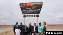 Bears Ears National Monument Inter-Governmental Cooperative Agreement signatories stand in front of a newly-unveiled sign, June 18, 2022.