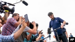President Joe Biden speaks to members of the media as he goes on a bike ride in Gordons Pond State Park in Rehoboth Beach, Delaware, July 10, 2022. 