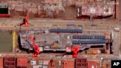 FILE - This satellite image from Maxar Technologies shows construction of a Chinese aircraft carrier at the Jiangnan Shipyard northeast of Shanghai, China, May 31, 2022. China launched is first "intelligent" drone carrier on May 18, in another effort to flex its muscles at sea.