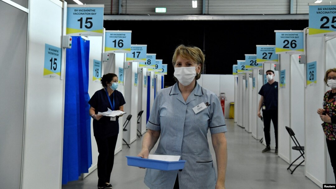 FILE - A nurse carries a tray of COVID-19 vaccine boosters at a vaccination site in Dublin, Ireland, Jan. 12, 2022.