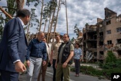 Australian Prime Minister Anthony Albanese, second left, listens to a translator during his visit to Irpin, on the outskirts of Kyiv, Ukraine, July 3, 2022.