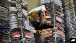 Nadia Zanola, chairman of the Cose di Maglia and owner of the D.Exterior brand, goes through racks of clothing at a warehouse section of unsold clothes, in Brescia, Italy, June 14, 2022.