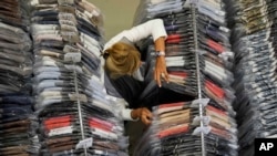 Nadia Zanola, president of Cose di Maglia and owner of the D.Exterior brand, checks clothing racks in an unsold clothing warehouse section, in Brescia, Italy, on June 14, 2022.