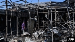 A man looks at the damage caused to the central market in Sloviansk by a suspected missile attack. 