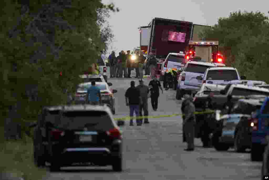 Police and first responders work at the place where officials say dozens of people were been found dead and multiple others were taken to hospitals with heat-related illnesses after a truck containing suspected migrants was found, June 27, 2022, in San Antonia, Texas.