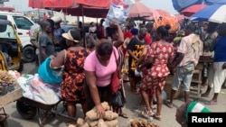 FILE - People shop at a fresh food market in Oyingbo, Lagos, Nigeria. Taken 12.17.2021