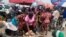 FILE - People shop at a fresh food market in Oyingbo, Lagos, Nigeria. Taken 12.17.2021
