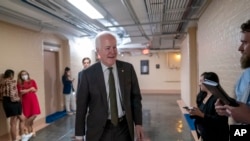 Sen. John Cornyn, R-Texas, arrives to meet with Sen. Chris Murphy, D-Conn., and Sen. Kyrsten Sinema, D-Ariz., for more bipartisan talks on how to rein in gun violence, at the Capitol in Washington, June 15, 2022. 