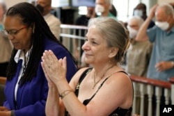 Amy Zowniriw, niece of Igal Roodenko, applauds an announcement by a judge in Hillsborough, N.C., Friday, June 17, 2022, that the conviction of her uncle, civil rights leader Bayard Rustin, and two other men were vacated.