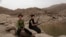 FILE - A 17 year-old boy holds his weapon at the High dam in Marib, Yemen, July 30, 2018. 